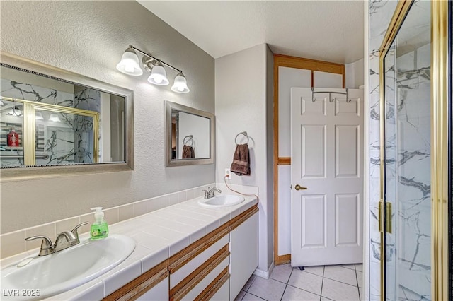 bathroom featuring vanity, tile patterned flooring, and a shower with door