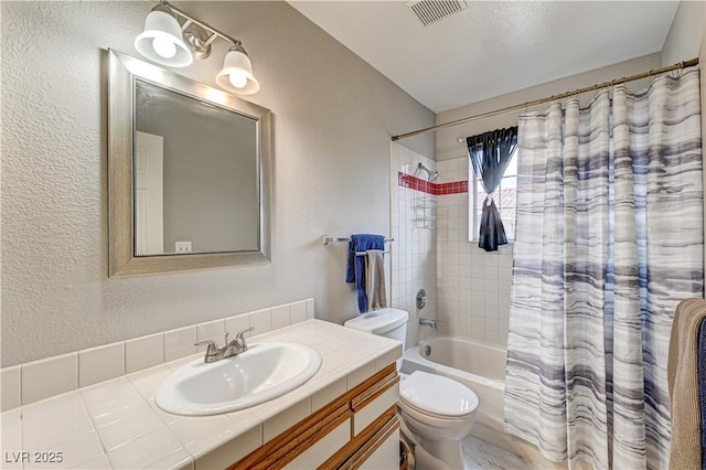 full bathroom featuring vanity, shower / bath combination with curtain, and toilet