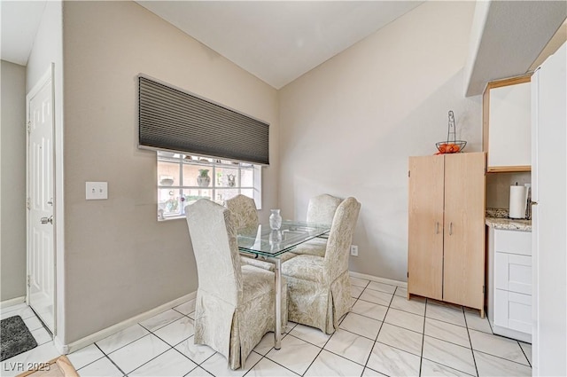 dining area featuring light tile patterned flooring