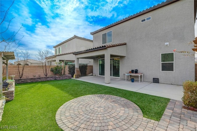 back of house featuring a patio area and a lawn