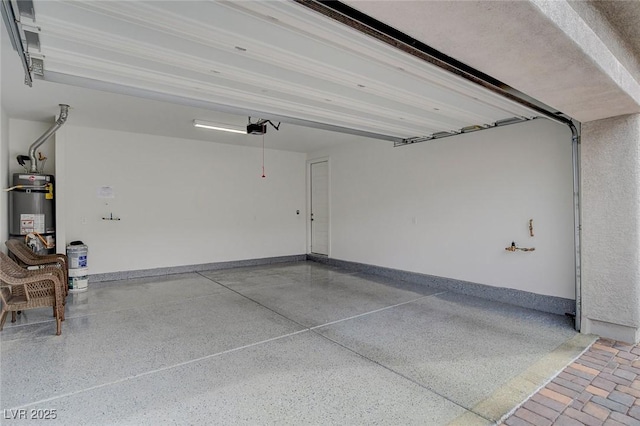 garage with a garage door opener and gas water heater