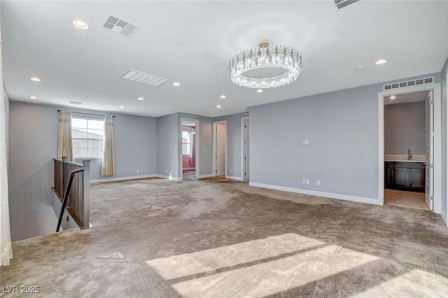 carpeted spare room featuring sink