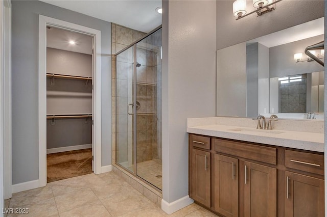 bathroom featuring an enclosed shower, vanity, and tile patterned floors