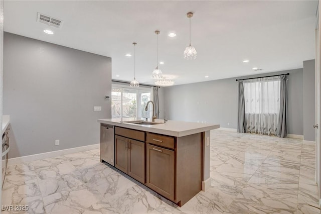 kitchen with hanging light fixtures, sink, an island with sink, and dishwasher