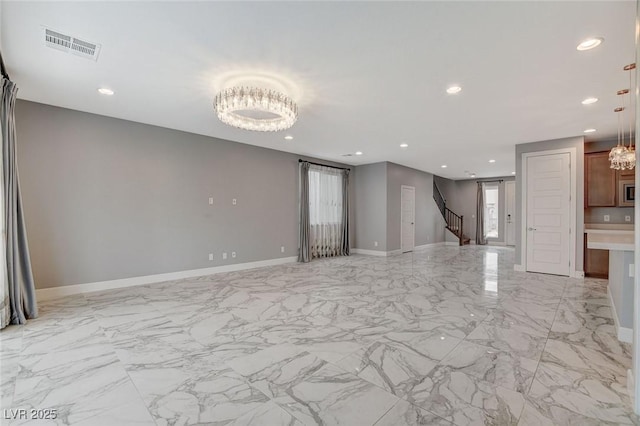 unfurnished living room featuring a notable chandelier