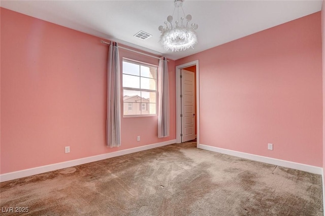 empty room with a chandelier and carpet