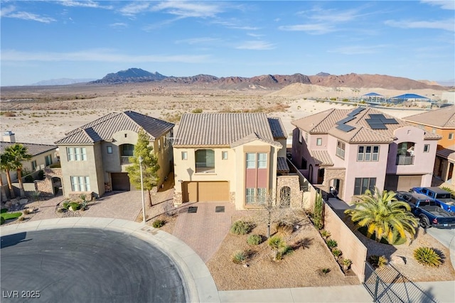 view of front of house with a garage and a mountain view