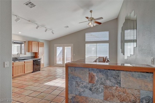 kitchen with sink, black dishwasher, light tile patterned flooring, light brown cabinetry, and vaulted ceiling