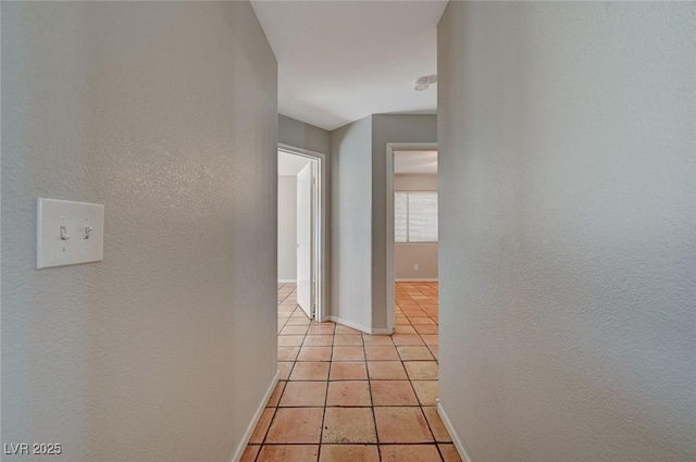 hallway featuring light tile patterned flooring