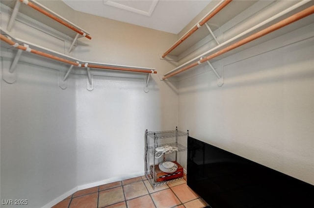 walk in closet featuring light tile patterned floors