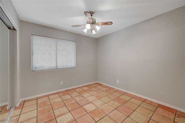 empty room with light tile patterned flooring and ceiling fan