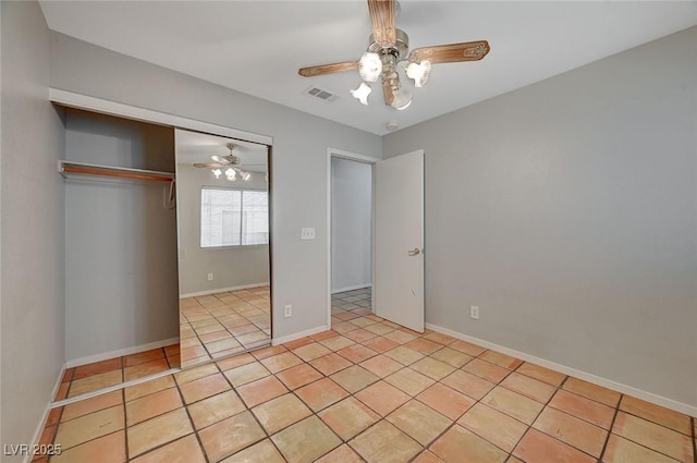 unfurnished bedroom with light tile patterned flooring, ceiling fan, and a closet