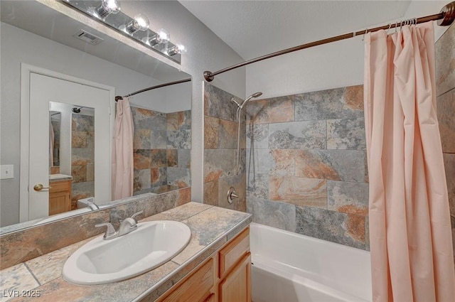 bathroom with vanity and shower / bath combination with curtain