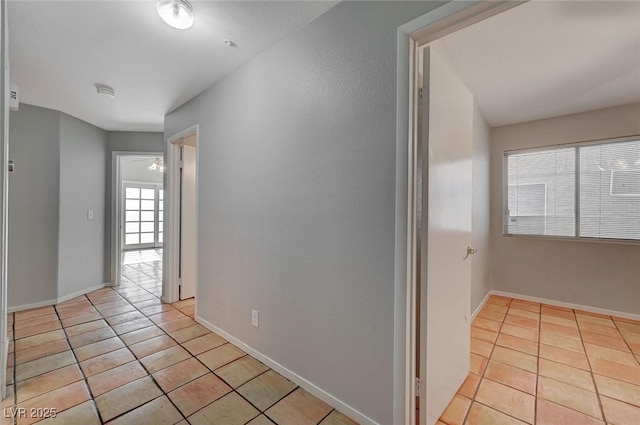 hall featuring light tile patterned floors