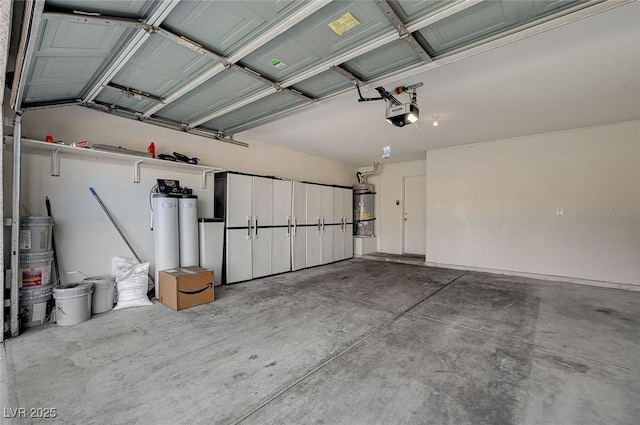 garage with a garage door opener and secured water heater