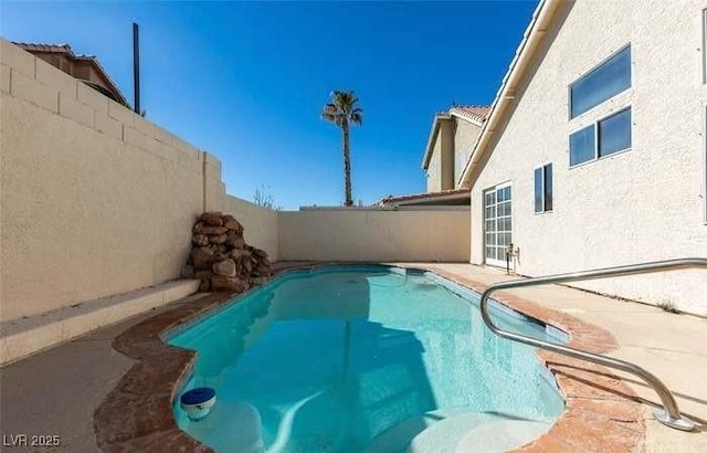 view of swimming pool with a patio area