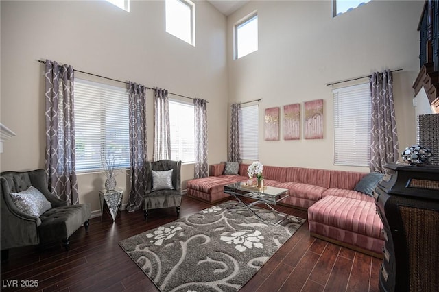 living room featuring dark wood-type flooring and a wealth of natural light