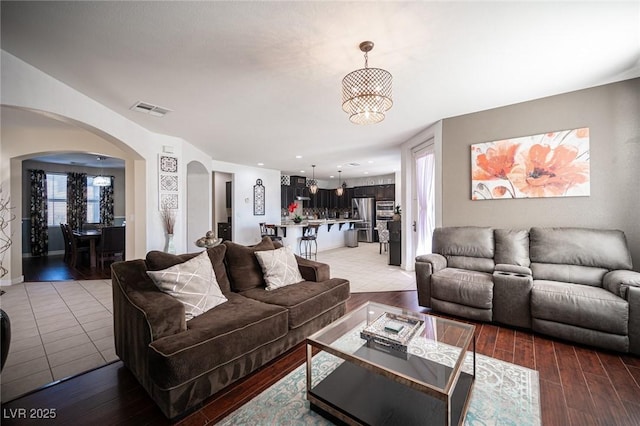 living room with an inviting chandelier and hardwood / wood-style floors