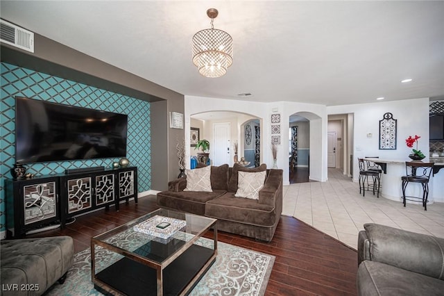 living room featuring a notable chandelier and wood-type flooring