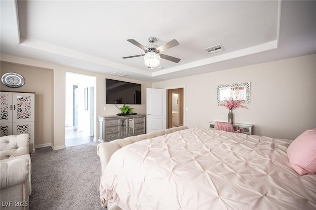 bedroom featuring ceiling fan, a raised ceiling, and light carpet