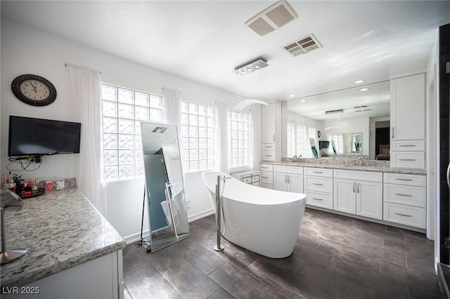 bathroom with vanity and a tub to relax in