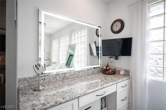 bathroom with a healthy amount of sunlight and vanity