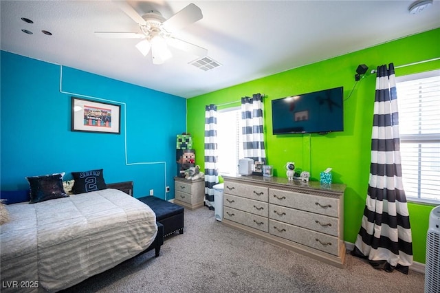 carpeted bedroom with multiple windows and ceiling fan