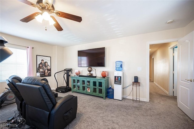 living room featuring ceiling fan and carpet