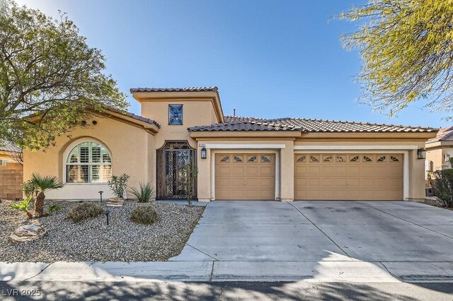 mediterranean / spanish home featuring a garage