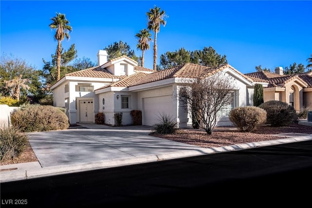 mediterranean / spanish home with a garage