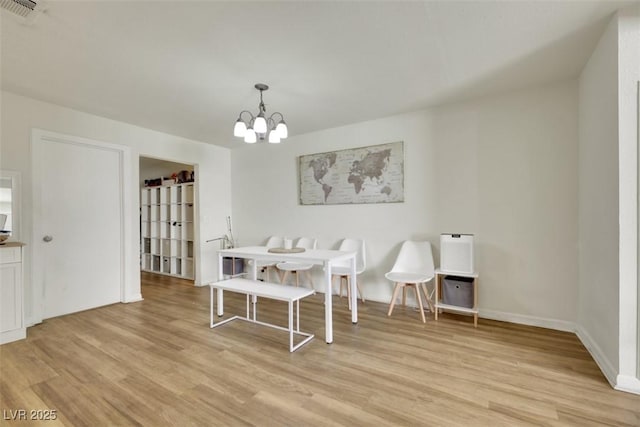 3473 Monte Carlo Dr, Las Vegas, NV 89121 - dining room with light wood-style floors and a chandelier