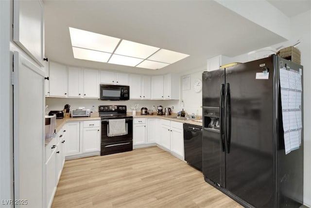 3473 Monte Carlo Dr, Las Vegas, NV 89121 - kitchen with black appliances, light countertops, and white cabinetry