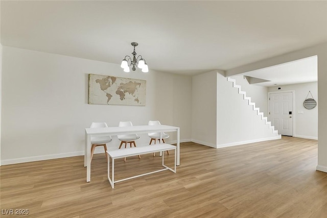 3473 Monte Carlo Dr, Las Vegas, NV 89121 - dining space with a chandelier, stairway, and light wood-type flooring
