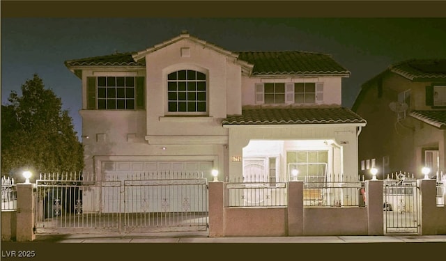 back house at night featuring a garage