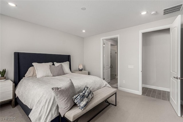 carpeted bedroom featuring ensuite bathroom