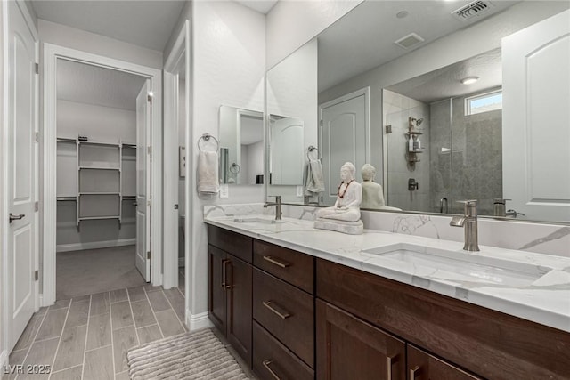 bathroom with vanity and a shower with door