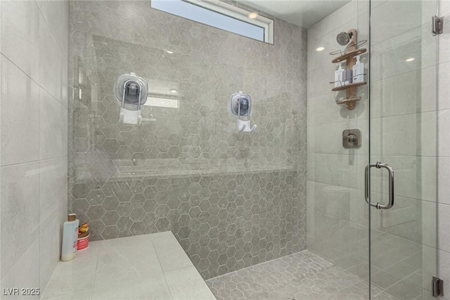 bathroom featuring a shower with shower door