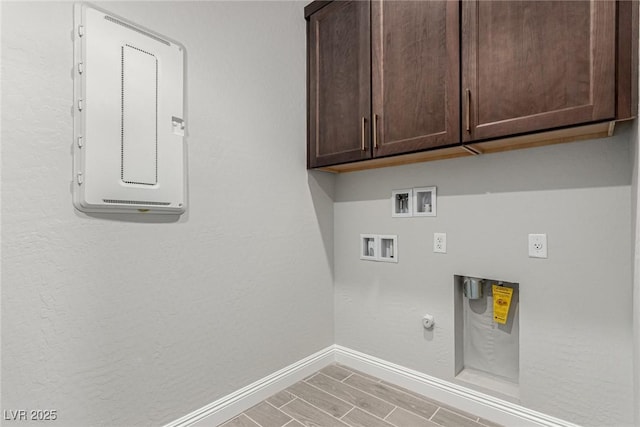 washroom featuring cabinets, gas dryer hookup, electric dryer hookup, and washer hookup