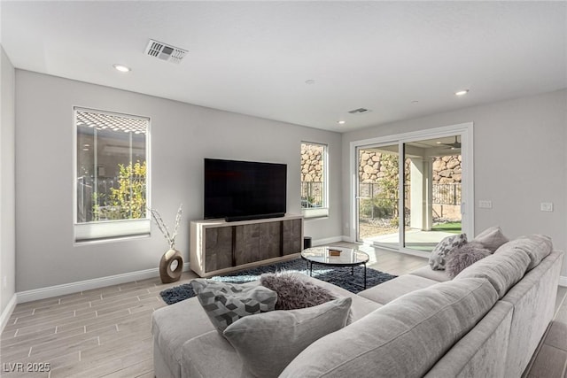 living room featuring light hardwood / wood-style flooring and a healthy amount of sunlight