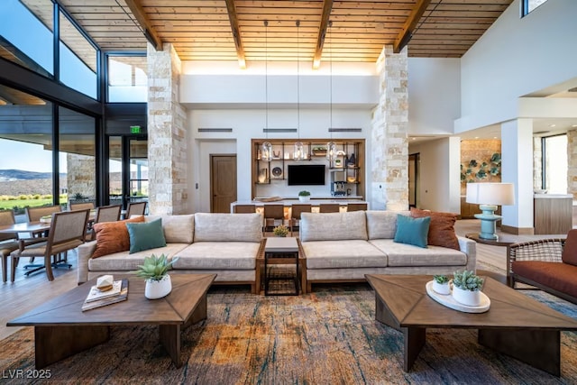 living room featuring beamed ceiling, a mountain view, dark hardwood / wood-style floors, and wooden ceiling