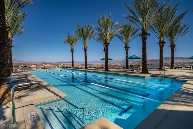 view of pool featuring a mountain view and a patio area