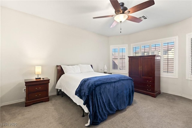 carpeted bedroom with ceiling fan and multiple windows