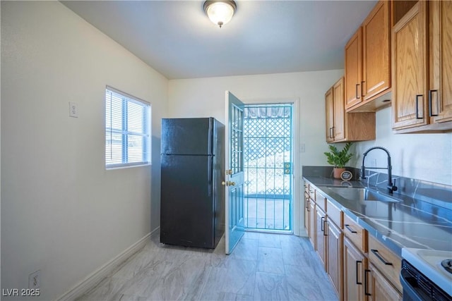 kitchen featuring black fridge, sink, and white electric range