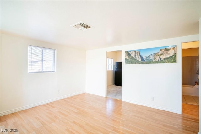 spare room with light hardwood / wood-style floors