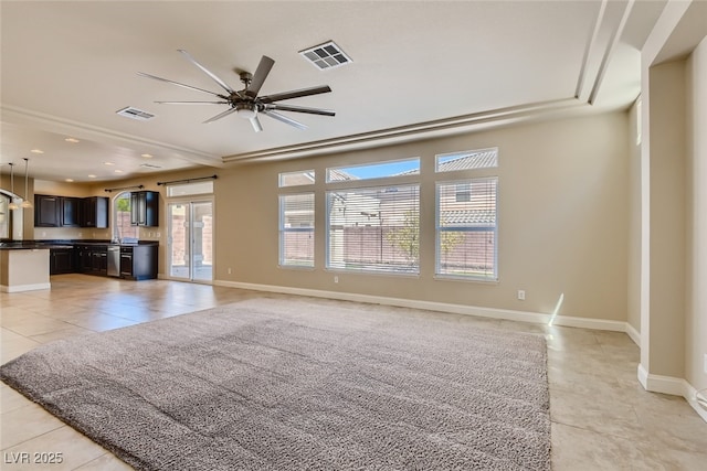 unfurnished living room featuring ceiling fan and light tile patterned floors