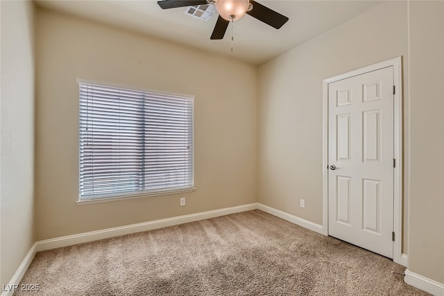 unfurnished room with ceiling fan and carpet flooring