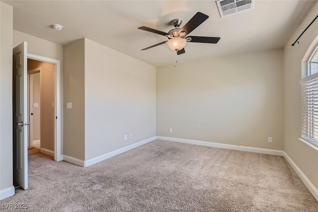 carpeted empty room featuring ceiling fan