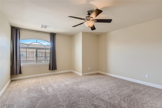 empty room featuring light colored carpet and ceiling fan