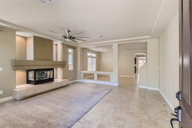 unfurnished living room with ceiling fan and light tile patterned floors