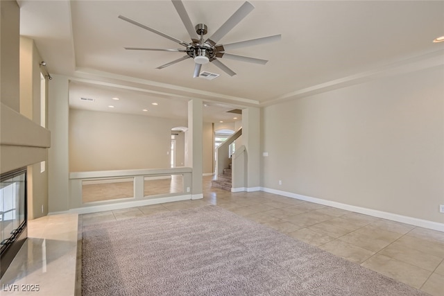 unfurnished living room with ceiling fan and light tile patterned flooring